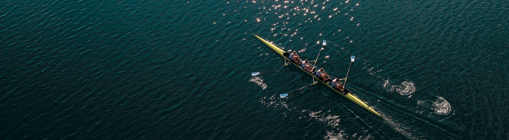 leadership team rowing boat in sync